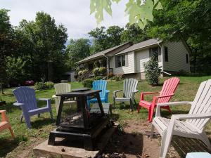 a group of chairs sitting around a table in a yard at Ole and Lena's Place in Bayfield