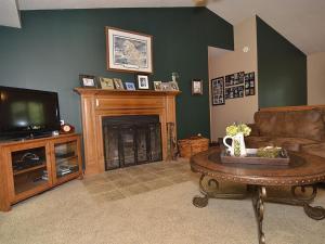 a living room with a fireplace and a television at Ole and Lena's Place in Bayfield +7 photos