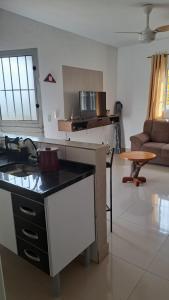 a kitchen and living room with a counter top at Chalé Zarinha I in Serra Negra