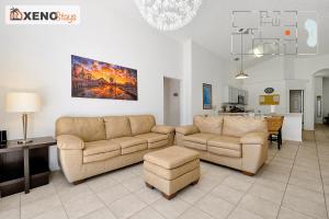 a living room with two couches and a table at XENOStays - Family Villa with Pool Near Disney in Kissimmee