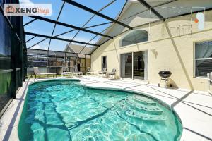 a swimming pool in a building with a glass ceiling at XENOStays - Family Villa with Pool Near Disney in Kissimmee