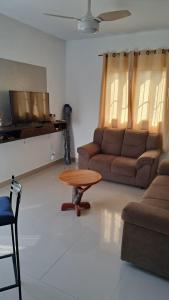 a living room with a couch and a coffee table at Chalé Zarinha I in Serra Negra