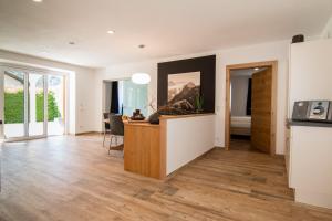 a living room with a kitchen and a dining room at Haus Arnold - Privatzimmer und Ferienwohnungen in Sillian