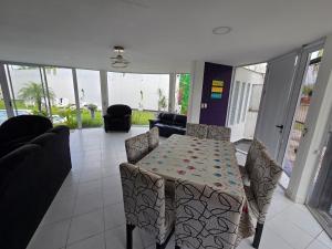 a living room with a table and chairs at Alisos Suite FC in El Ceibal