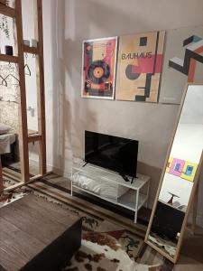 a living room with a tv on a wall at Trulli & Case Fichi 3 in Bari