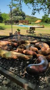 a bunch of food cooking on a grill at Casa Los Abuelos in La Granja