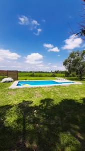 a swimming pool in the middle of a yard at Casa Los Abuelos in La Granja