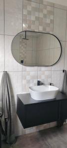 un baño con lavabo y espejo en 7atSapele, en Germiston