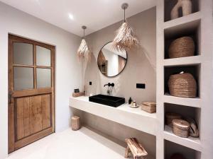 a bathroom with a sink and a mirror at Villa Victoire - Mini villas avec terrasse privée in Vauvenargues +11 photos