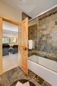 a bathroom with a tub and a glass shower at Challenger Cabin in Big Sky Mountain Village