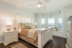 a bedroom with a bed and a ceiling fan at Stunning Gulf Views Firepit in Stingaree