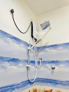 a bathroom with a shower with a painting of the ocean at Sahas Homestay in Tangalle +29 photos
