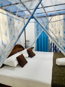 a bed in a tent with two pillows on it at Sahas Homestay in Tangalle