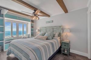 a bedroom with a bed and a ceiling fan at Island Winds East Condo 402 in Gulf Shores