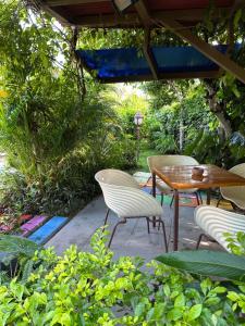 un patio avec une table, des chaises et des arbres dans l'établissement Camino el Valle de Antón km7, à San Carlos