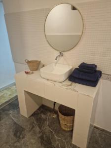 a bathroom with a sink and a mirror on a counter at Lemon grass house in Binguni