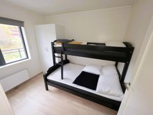 two bunk beds in a small room with a window at Nice apartment in the center of Trysil 403 in Trysil