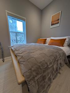 a bedroom with a large bed with a large window at Church Suites Enniskillen in Enniskillen