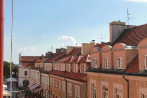 a row of buildings with red roofs on a street at Apartament na Małym Rynku in Sandomierz