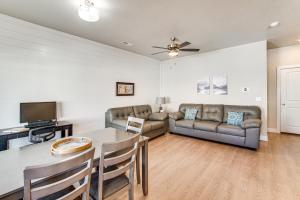 a living room with a table and a couch at 25 Mi to Cedar Breaks Unit with Furnished Patio! in Enoch