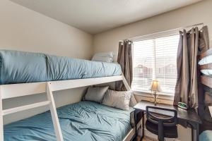 a small room with a bunk bed and a desk at 25 Mi to Cedar Breaks Unit with Furnished Patio! in Enoch