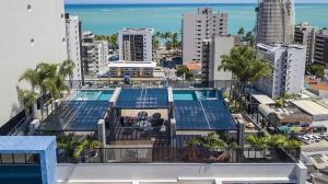an overhead view of a building with a swimming pool at Edifício Time - studios em Maceió in Maceió