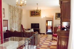a living room with a couch and a table at Mas Abicou in Vézénobres
