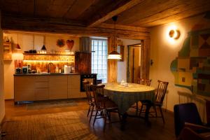 a kitchen and dining room with a table and chairs at Podgórska in Lanckorona +10 photos