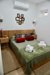 a bedroom with two beds with red pillows at Casa Tapada do Bento II- Albufeira in Albufeira +120 photos