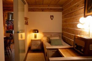 a small room with a bed and a lamp at Podgórska 7 in Lanckorona