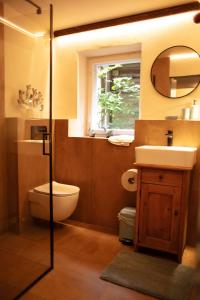 a bathroom with a toilet and a sink and a mirror at Podgórska in Lanckorona
