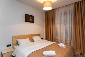 a bedroom with a bed with two towels on it at 1BR Apart In Kokhta Mitarbi in Bakuriani