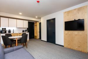 a living room with a table and a kitchen at 1BR Apart In Kokhta Mitarbi in Bakuriani