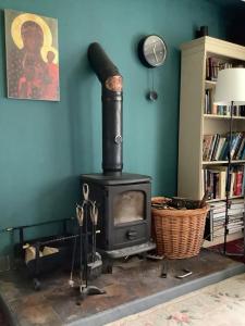 a stove in a living room with a book shelf at Lowry House Hotel in Walsall in Birmingham