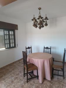 a dining room with a pink table and chairs at Casa Das Manas - Pardais in Alandroal +7 photos