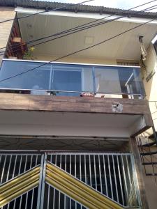 a sliding glass door on a balcony of a house at Kit Net perto da vila cop30 in Belém