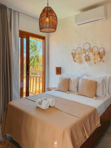 Postel nebo postele na pokoji v ubytování Maré Mansa Suítes Icaraizinho