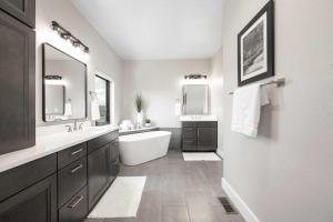a bathroom with a tub and a sink and mirror at Saddle Ridge, 0021 in Granby +40 photos
