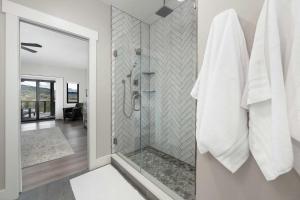 a bathroom with a shower with a glass door at Saddle Ridge in Granby +40 photos