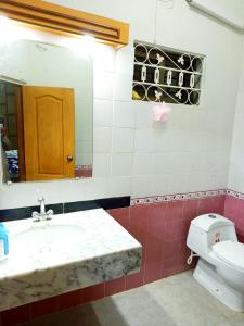 a bathroom with a sink and a toilet and a mirror at Skyline Serenity Guest House in Rawalpindi
