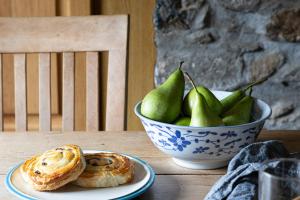 a bowl of pears and a bowl of bread on a table at Myrtle Grove in Saint Endellion