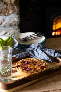 a table with a plate of food and a pizza at Myrtle Grove in Saint Endellion