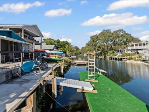 a house on a river with boats in the water at The Hideaway at Weeki Wachee in Weeki Wachee