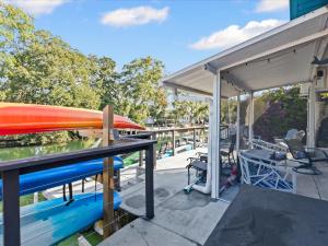 a patio with a table and surfboards on it at The Hideaway at Weeki Wachee in Weeki Wachee +77 photos