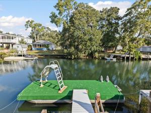a boat dock with a ladder on a lake at The Hideaway at Weeki Wachee in Weeki Wachee
