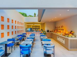 a restaurant with blue chairs and a counter at Echinus Blue Hotel in Antalya