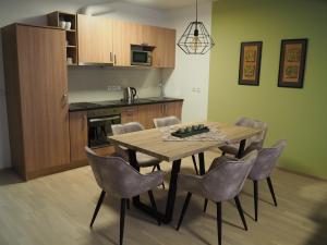 a kitchen and dining room with a wooden table and chairs at Apartmán P7 Horní Mísečky in Horni Misecky