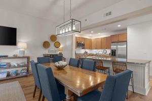 a dining room and kitchen with a wooden table and chairs at Redfish Village M2-329 in Blue Mountain Beach
