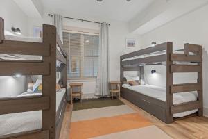 a bedroom with two bunk beds and a desk at Redfish Village M2-329 in Blue Mountain Beach +62 photos