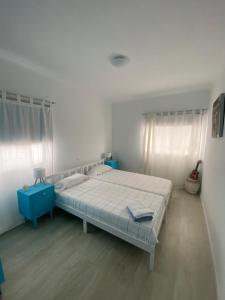 a bedroom with a bed and a blue cabinet in it at Hotel Jardim Oudinot "MyWay Kite&Surf" in Ílhavo